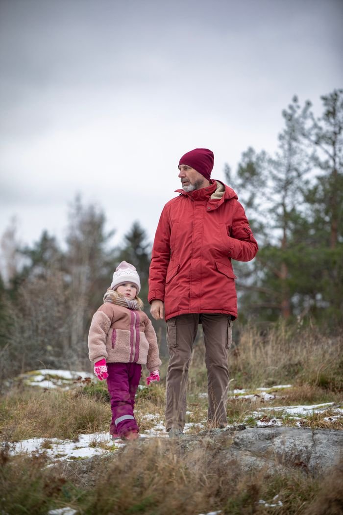 A father and daughter enjoy a winter walk in the countryside. Captured on Canon EOS 5D Mark IV.